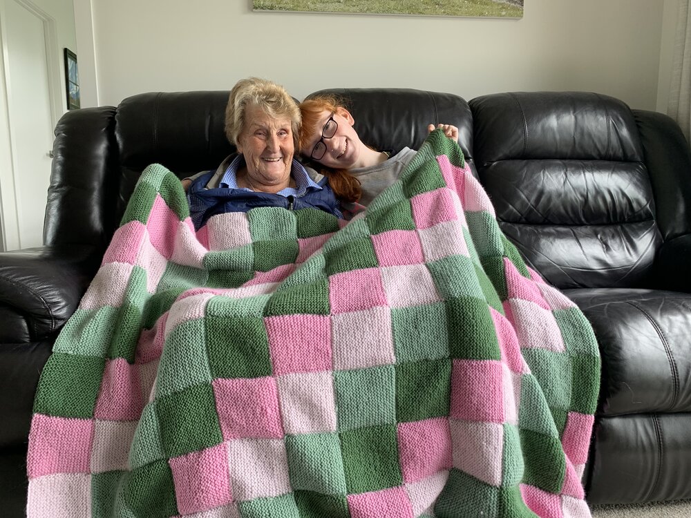 Knitters with peggy square blanket