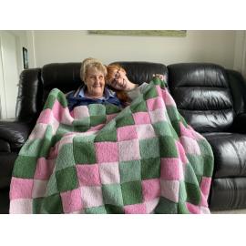 Knitters with peggy square blanket